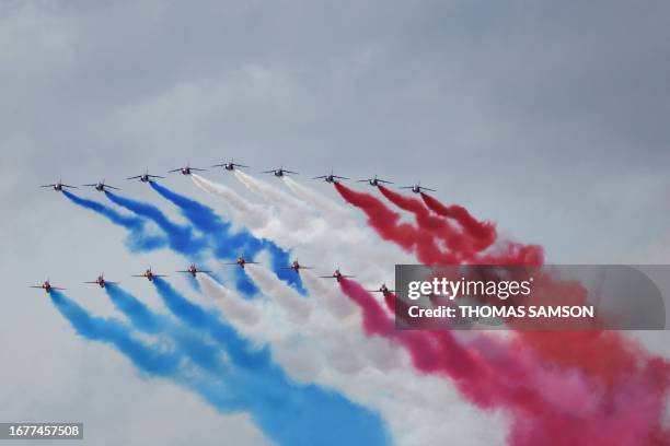 French Air Force elite acrobatic flying team "Patrouille de France" and the British Royal Air Force's aerobatic team the "Red Arrows" perform a fly...
