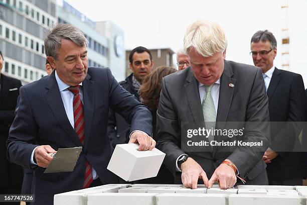 Wolfgang Niersbach, president of the German Football Association and Ullrich Sierau, mayor of Dortmund lay down stones at construction area during...