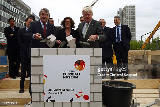 Wolfgang Niersbach, president of the German Football Association and Ullrich Sierau, mayor of Dortmund lay down stones at construction area during...
