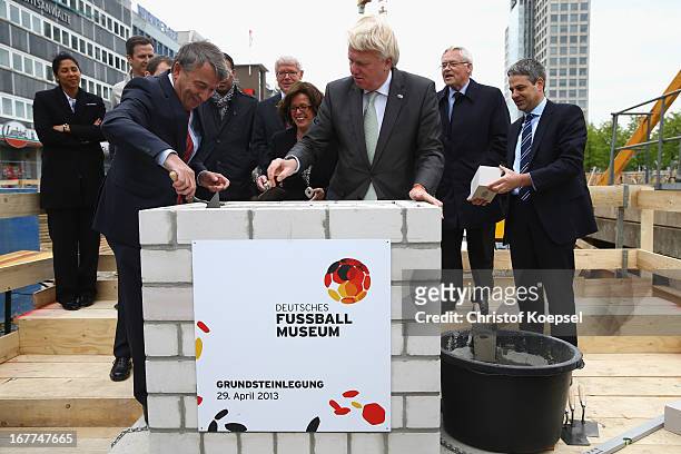 Wolfgang Niersbach, president of the German Football Association and Ullrich Sierau, mayor of Dortmund lay down stones at construction area during...