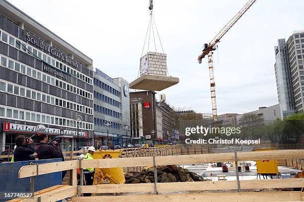 Part of masonry hangs on a crane at the construction area during the DFB Football Museum groundbreaking ceremony at Koenigswall on April 29, 2013 in...