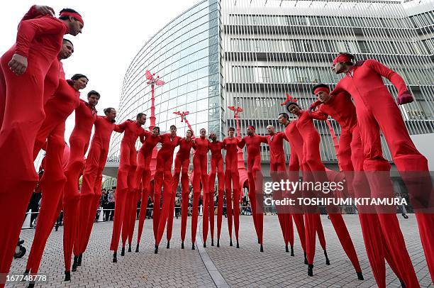 French performance group Compagnie Off members gather before performing 'Les Girafes', a stilt-walking show, at Roppongi Hills in Tokyo on April 29,...