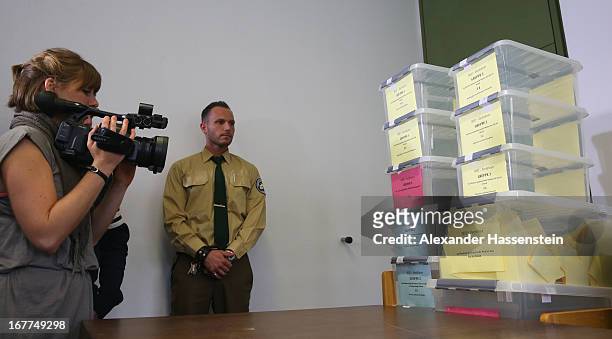 Police officer stands next to a lottery box during the media conference following the lottery draw for the 50 media spots inside the courtroom for...