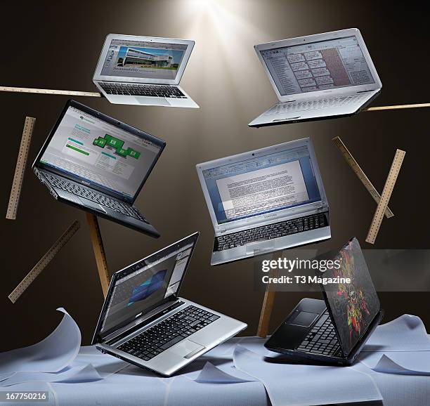 Selection of laptop computers surrounded by graph paper and rulers for an article on university-suitable laptops, including Apple MacBook 11-inch,...