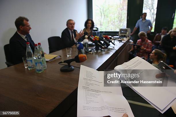 Journalist read the press statement of the Oberlandgericht Muenchen court during a press conference after the the lottery draw for the 50 media spots...