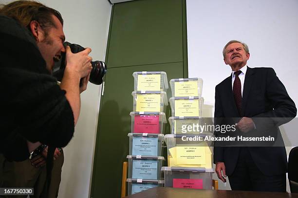 Karl Huber, President of the Oberlandgericht Muenchen court stands next to the lottery boxes after a press conference following the lottery draw for...