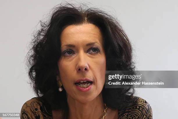 Andrea Titz, of the press department of the Oberlandesgericht Muenchen state court, speaks to the media following the lottery draw for the 50 media...