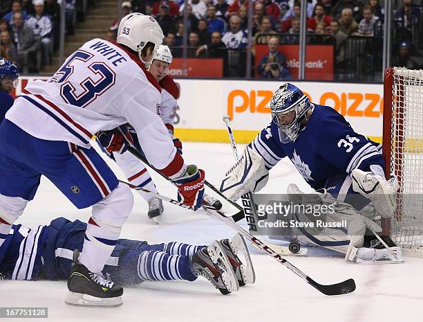 Toronto Maple Leafs goalie James Reimer makes a stop on Montreal Canadiens center Ryan White as the Toronto Maple Leafs play the Montreal Canadiens...