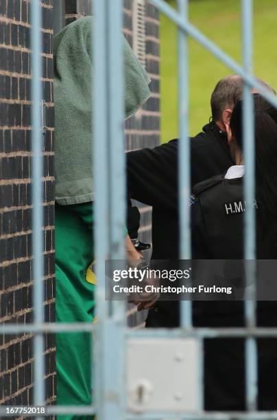 Mark Bridger leaves Mold Crown Court covered with a blanket after the first day of his trial accused of the murder of April Jones, on April 29, 2013...