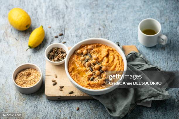 homemade chickpea houmous with pumpkin seeds sesame and lemon - tahini stock pictures, royalty-free photos & images