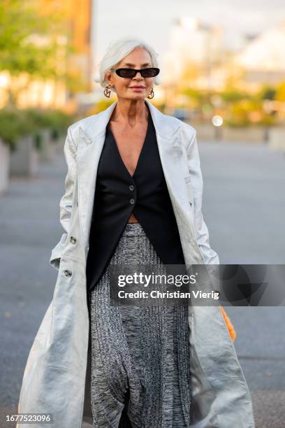 Grece Ghanem wears white coat, grey skirt outside COS on September 12, 2023 in New York City.