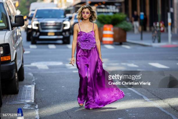 Guest wears purple dress outside Carolina Herrera on September 12, 2023 in New York City.
