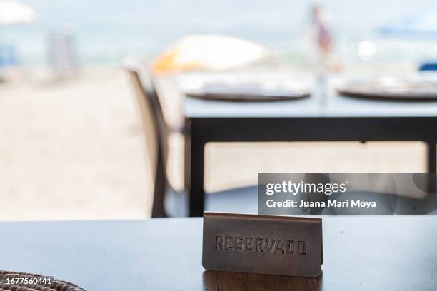 reservation sign, on a restaurant table on the beach - almeria restaurant stock-fotos und bilder