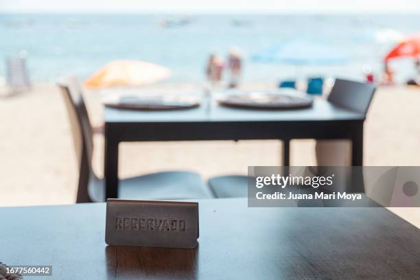 reservation sign, on a restaurant table on the beach - almeria restaurant stock-fotos und bilder