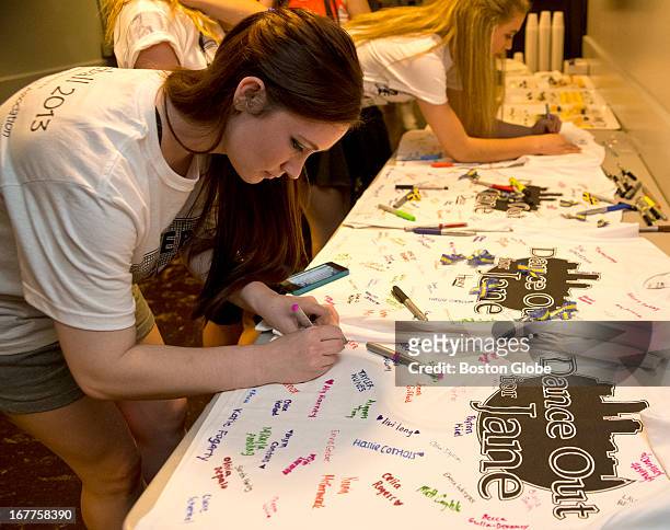 Erin Kiley a step dancer from Fairfield, Conn., and a dancer with the Lenihan School, signs a T-shirt backstage for Jane Richard, during a benefit...