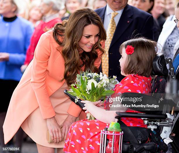 Catherine, Duchess of Cambridge is presented with a posy of flowers by Sally Evans as she visits Naomi House Children's Hospice, to celebrate...