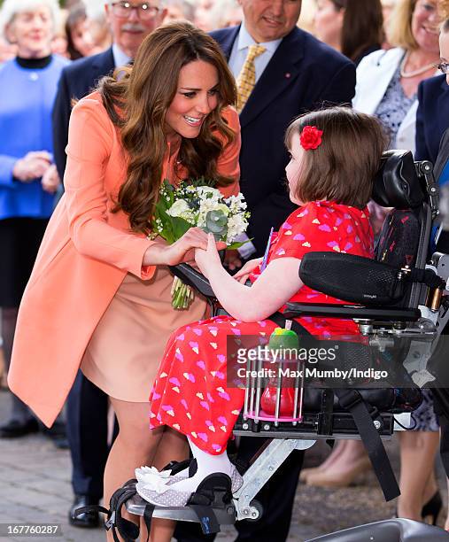 Catherine, Duchess of Cambridge is presented with a posy of flowers by Sally Evans as she visits Naomi House Children's Hospice, to celebrate...
