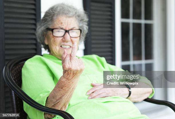 grandma flipping the bird from her front porch - middle finger funny 個照片及圖片檔