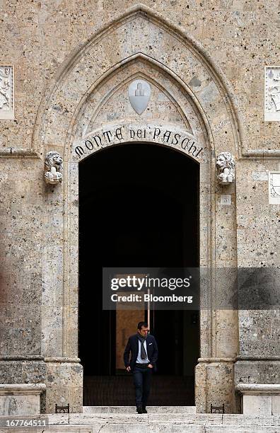 Pedestrian leaves the headquarters of Banca Monte dei Paschi di Siena SpA in Siena, Italy, on Monday, April 29, 2013. An Italian judge rejected a...