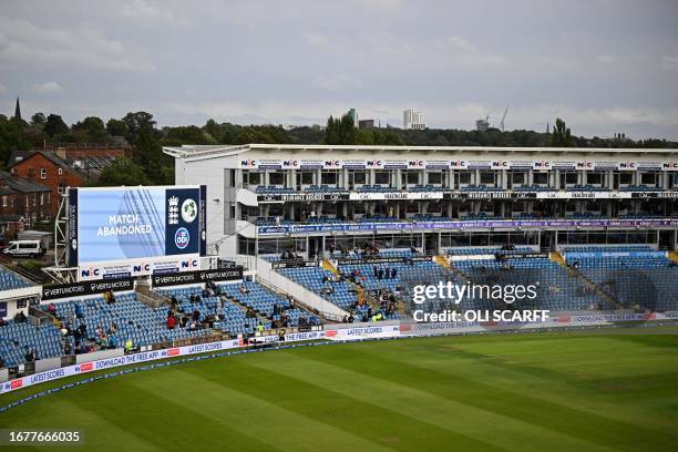 Screen reading "match abandoned" is pictured to announce that the first One Day International cricket match between England and Ireland at Headingly,...