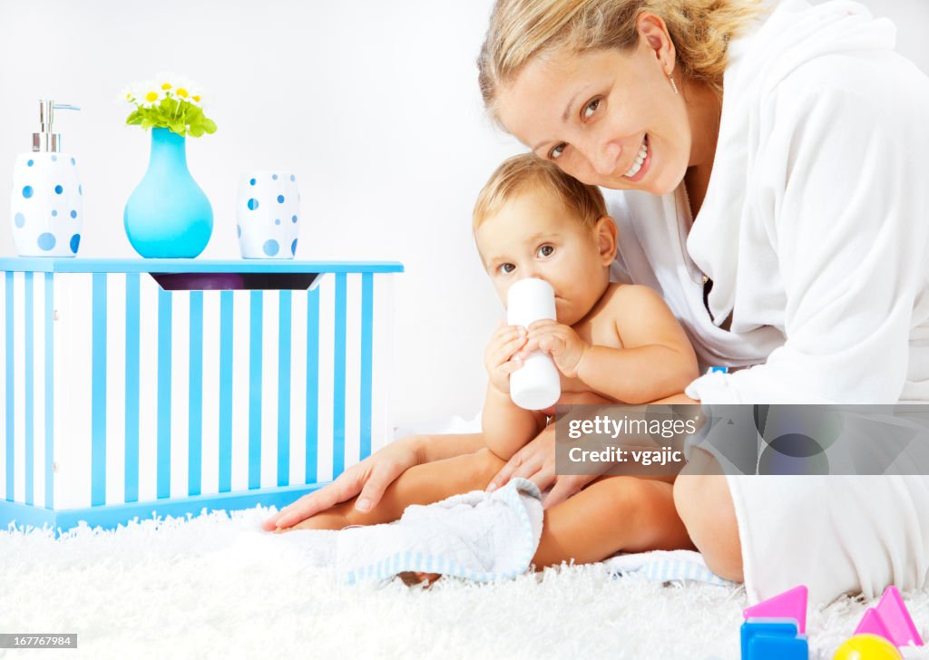 Mother and baby daughter portrait after bath