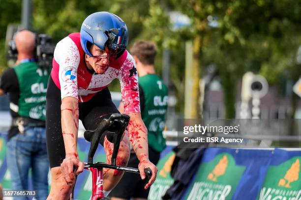 Stefan Kung of Switzerland finishes with a broken helmet and covered with blood after competing in the Men's Individual Time Trial of the 2023 UEC...