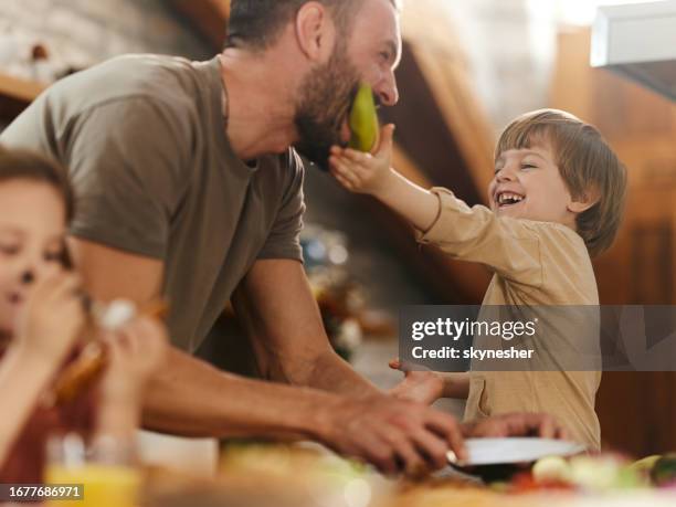 single father having fun with his kids in dining room. - female eating chili bildbanksfoton och bilder