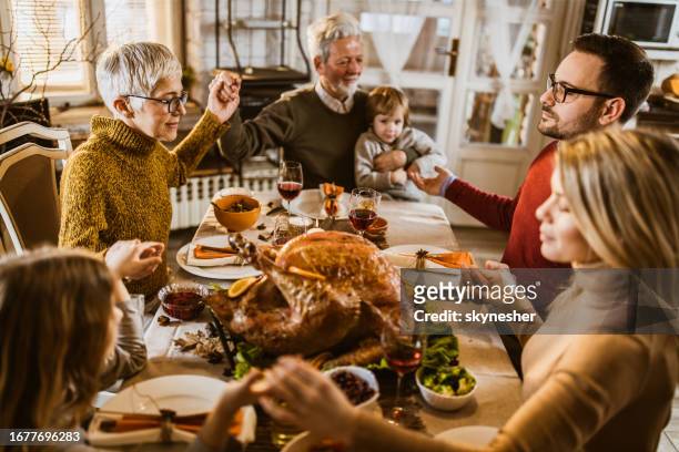 praying before thanksgiving lunch! - serbia tradition stock pictures, royalty-free photos & images