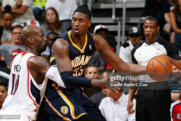 Roy Hibbert of the Indiana Pacers drives against Johan Petro of the Atlanta Hawks during Game Four of the Eastern Conference Quarterfinals of the...