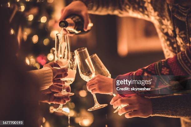 pouring champagne on new year's party! - poured stock pictures, royalty-free photos & images