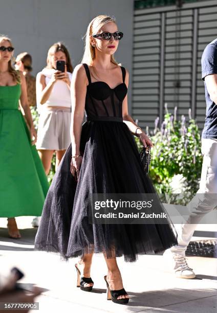 Guest is seen wearing a black bustier and black tule skirt with black sunglasses and black heels outside the Carolina Herrera show during NYFW S/S...