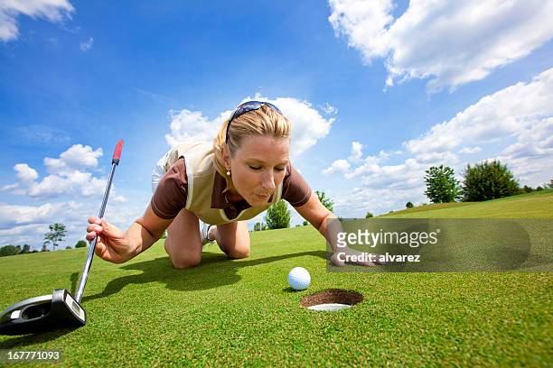 woman golfer cheating - golf cheating stock pictures, royalty-free photos & images