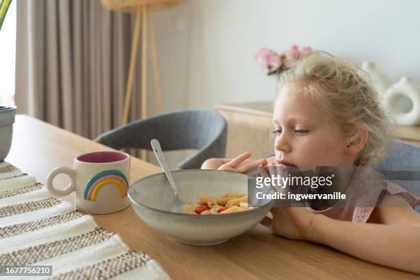 girl refusing to eat pasta for lunch - picky eater stockfoto's en -beelden