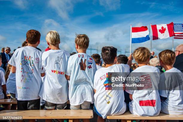 Young kids are seen attending the ceremony with messages in support of the USA and other countries written on their t-shirts, during the 79th...