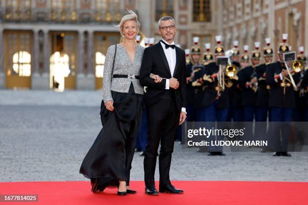 Elysee Palace General Secretary Alexis Kohler and his wife Sylvie Kohler arrive to attend a state banquet at the Palace of Versailles, west of Paris,...