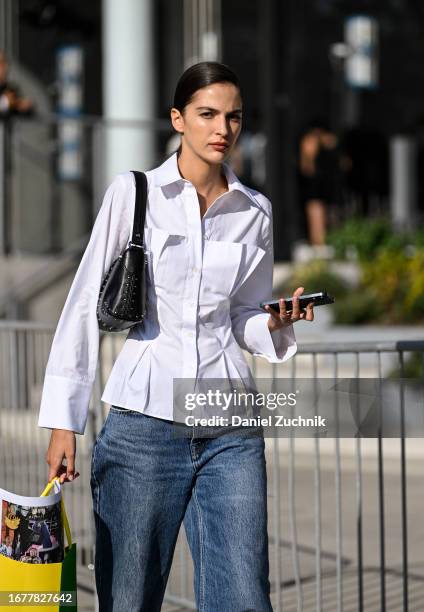Model Africa Garcia is seen wearing a white button down shirt, blue jeans and black bag outside the Carolina Herrera show during NYFW S/S 2024 on...