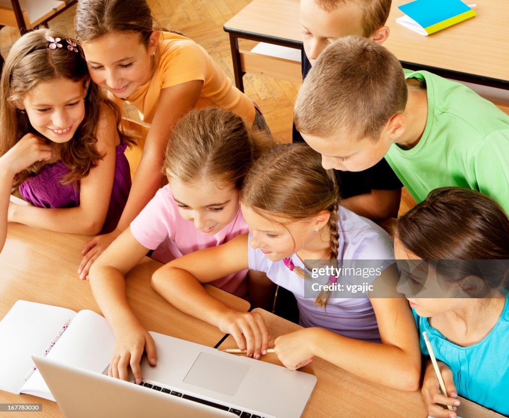 Having Classes Elementary Students Having Class With Laptop High-Res Stock Photo ...