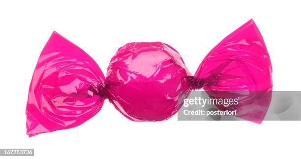 candy wrapped in pink foil - bonbons stockfoto's en -beelden