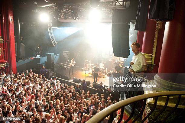 Frank Carter of Pure Love performs from the VIP balconey as the rest of Pure Love perform onstage during a sold out show at KOKO on April 18, 2013 in...