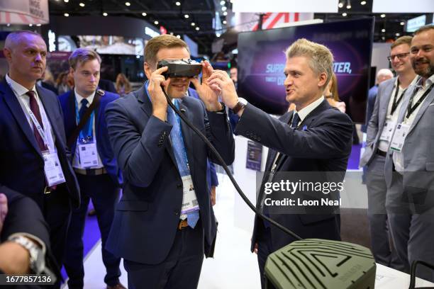 Estonian Defence Minister Hanno Pevkur tries on the viewfinder of the Vegvisir CORE mixed reality situational awareness system as he visits the...