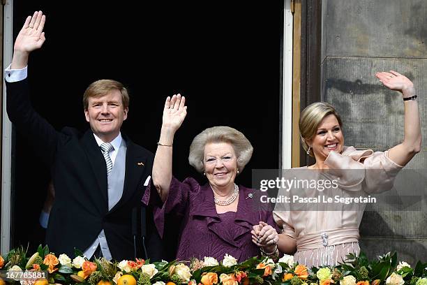 Queen Beatrix of the Netherlands with King Willem Alexander and Queen Maxima appear on the balcony of the Royal Palace to greet the public after her...