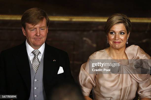 Prince Willem-Alexander of the Netherlands sits alongside his wife Princess Maxima of the Netherlands during the abdication ceremony of his mother...