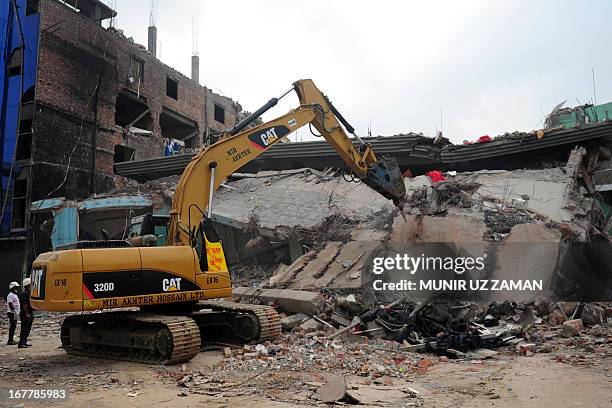 Bangladeshi rescuers work as Bangladeshi Army personel continue the second phase of the rescue operation using heavy equipment after an eight-storey...