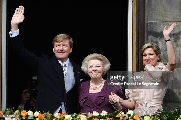 Queen Beatrix of the Netherlands with King Willem Alexander and Queen Maxima appear on the balcony of the Royal Palace to greet the public after her...