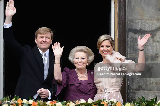 Queen Beatrix of the Netherlands with King Willem Alexander and Queen Maxima appear on the balcony of the Royal Palace to greet the public after her...