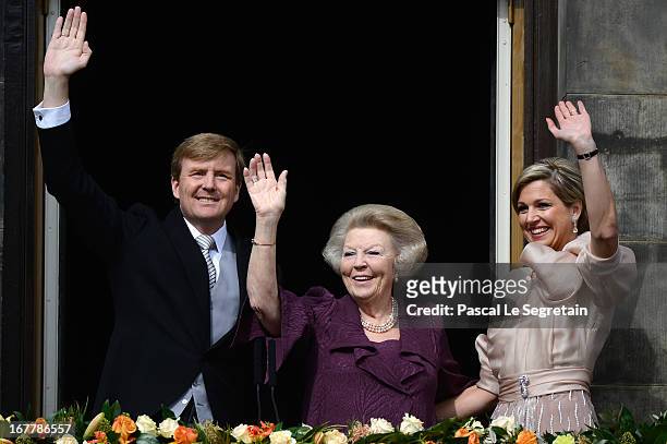 Queen Beatrix of the Netherlands with King Willem Alexander and Queen Maxima appear on the balcony of the Royal Palace to greet the public after her...