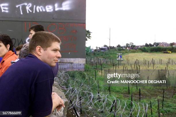 Young Protestant views barbed wire laid out by British soldiers near Drumeree Parish church a few miles from Portadown 03 July 1999. British troops...