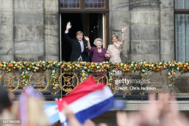 Princess Beatrix of the Netherlands with King Willem Alexander and Queen Maxima appear on the balcony of the Royal Palace to greet the public after...