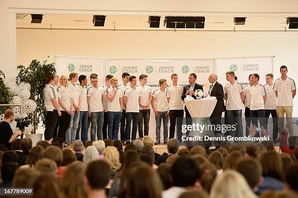 Assistant coach Hans-Dieter Flick talks to participants during the launch of the DFB and Commerzbank Junior Coach Program on April 30, 2013 in Mainz,...