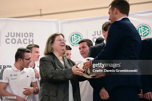 Assistant coach Hans-Dieter Flick hands over a present to Marita Desch-Eppelmann of Otto Schott Gymnasium during the launch of the DFB and...